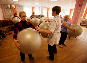 Older women with fit balls undertaking an exercise class