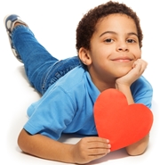 Child holding paper heart