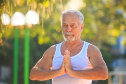 Older man doing yoga pose