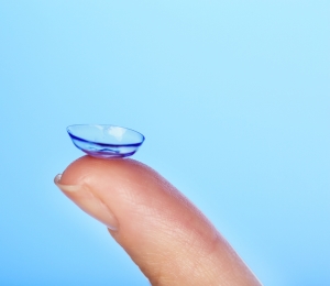 A contact lens held at the end of a finger