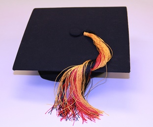 Image of a graduation cap with a tassel of Aboriginal colours 