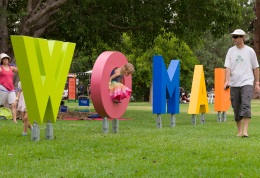 Man walking past WOMAD sign