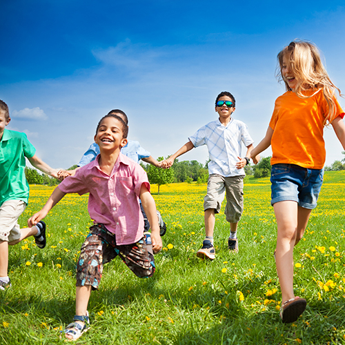 group of children running in a field