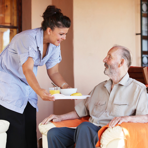 Man receiving a meal in a nursing home
