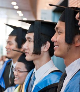 Side view of line of International students in caps and gowns
