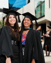 graduating students celebrate in fron of Hawke building