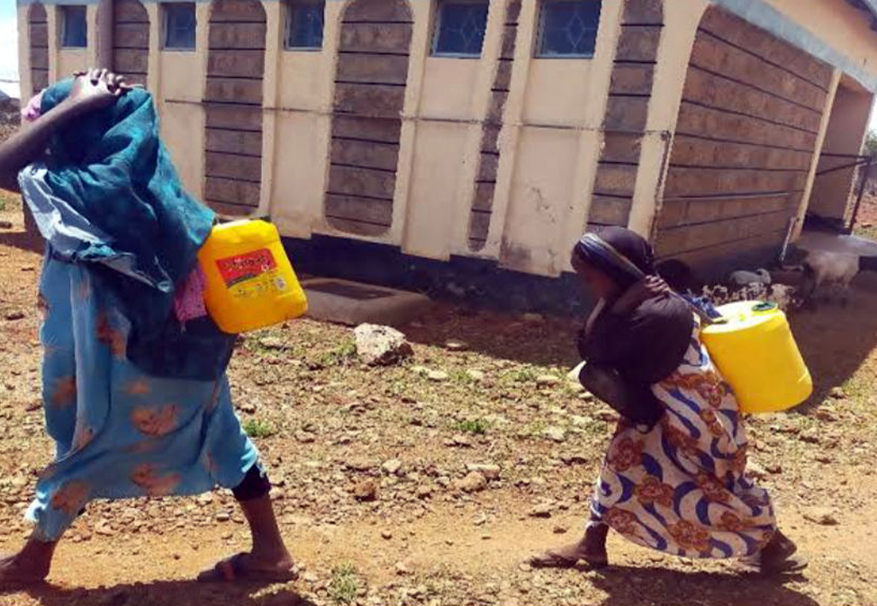 It was Muslima's experience of meeting a little girl with diabetes, pictured here carrying water behind her mother, that spurred her on to create Health Care Connect.