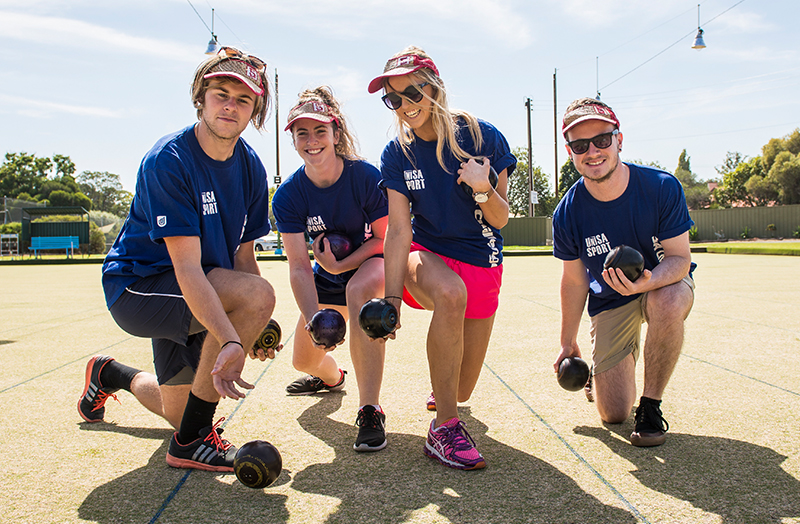 A team of people playing lawn bowls