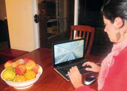 Woman sitting at laptop.