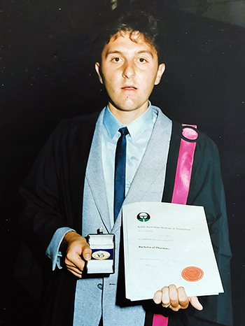 Stan at Graduation holding his Gold Medal for most outstanding Pharmacy student in 1986