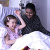 Volunteer Ayesha Fernando with leukaemia patient Sadie.