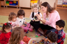 Early childhood educator with students sitting in a circle