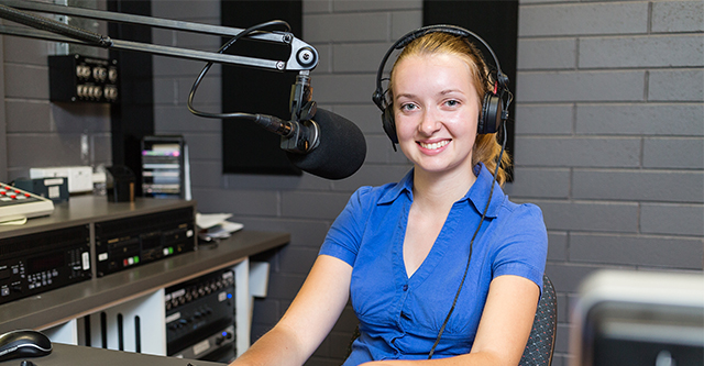 A woman sitting in a recording studio