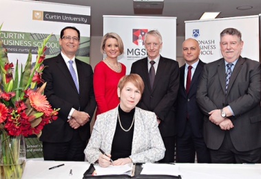 Prof Marie Wilson signing the Women in MBA agreement with colleagues from  the Curtin, Monash and Sydney Business Schools and the Macquarie Graduate School of Management.