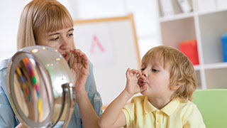 Speech Pathologist teaching small child