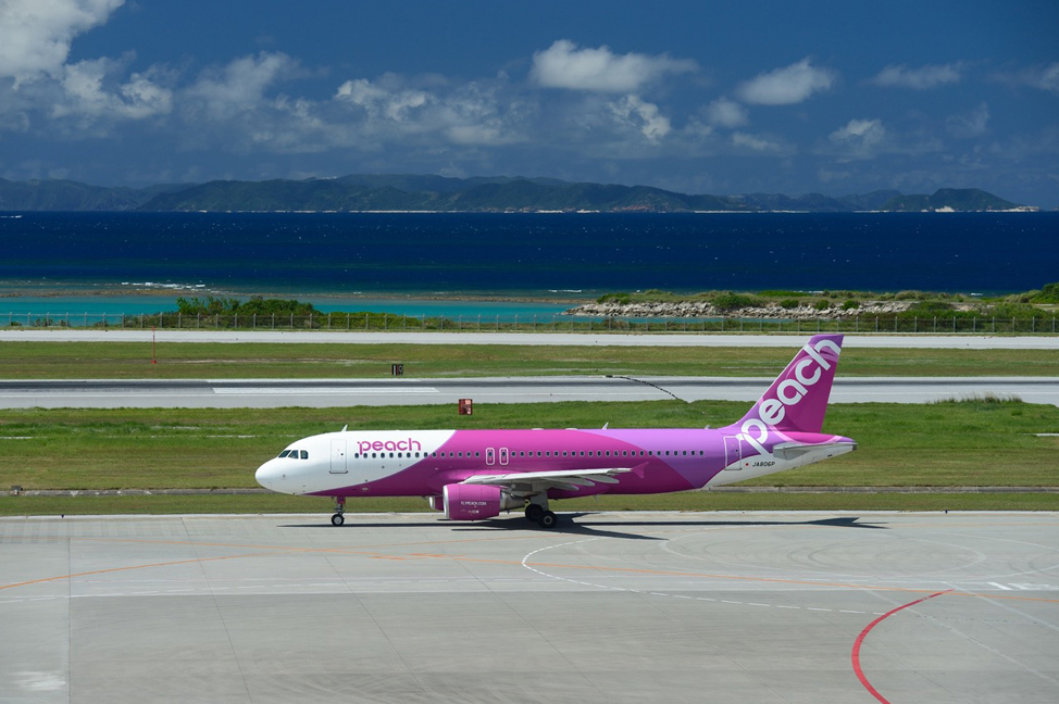 A Peach Aviation plane on the tarmac at Naha Airport, Okinawa, Japan.