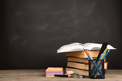 A stack of books among some stationery, shutterstock 520698886