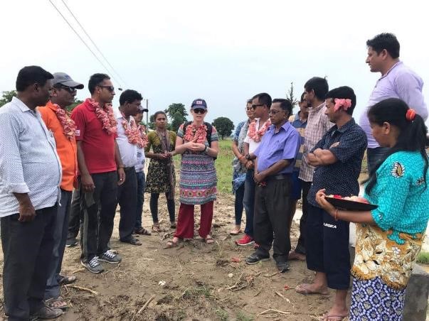 Becky-Jay discussing with the Nepal Red Cross team and community members