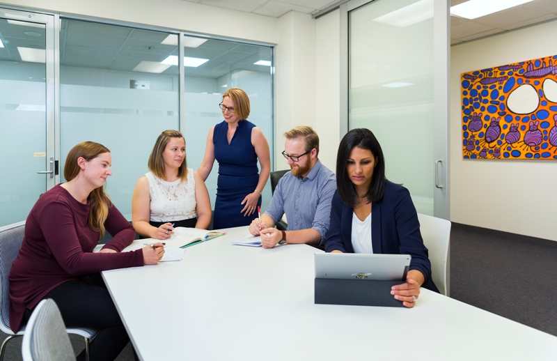 Researchers work at a conference table