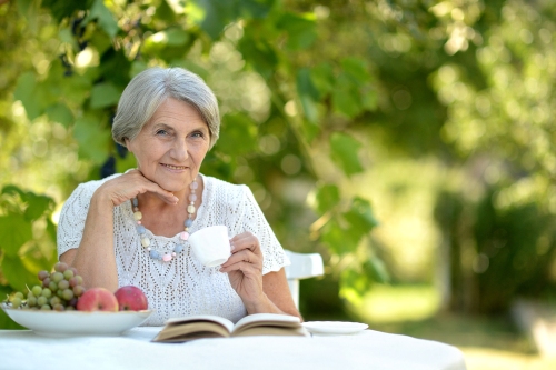 Elderly Woman Drinking Coffee Outside