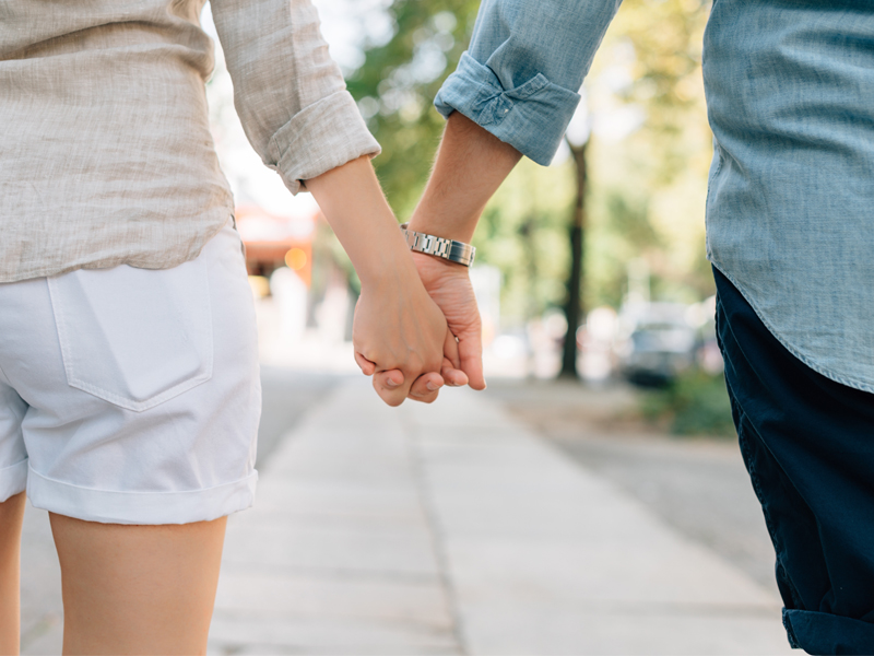 Man and a woman holding hands