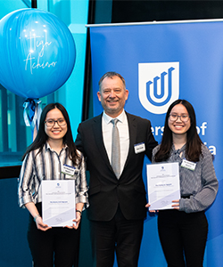 Anh Nguyen (left) and An Nguyen (right) receiving their Vice Chancellor’s International Excellence Scholarship  from Professor Allan Evans,  Provost and Chief Academic Officer,  at a recent awards ceremony.