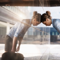 tired woman worker leaning on building