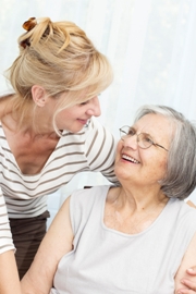 Middle aged female worker caring for her elderly mother