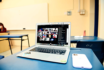 zoom session on a laptop in a classroom