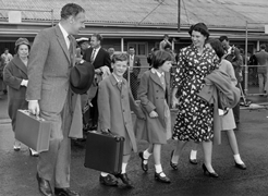 Sir Alick and Lady Downer with their three children  all carry suitcases ready for a trip.