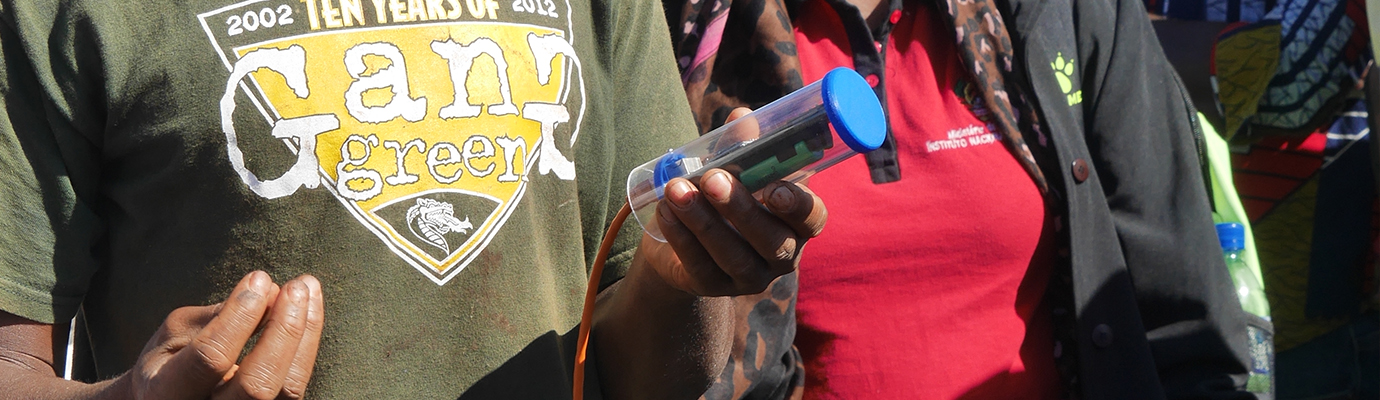 African man holding an irrigation monitoring device