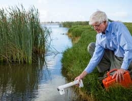 Professor Bill Cowley from the Institute for Telecommunications Research deploying a water temperature sensor at Gawler, South Australia.
