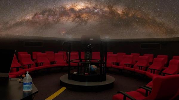 A starfield is projected above the planetarium