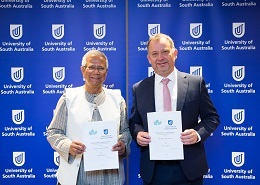 Professor Allan Evans with Nobel Laureate Professor Muhammad Yunus signing an MOU to deliver a Social Business Centre at UniSA.