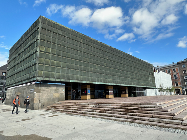 An open-air exhibition entitled “Hunger as a Weapon” sits under the brutalist Soviet building repurposed as the Museum of Occupation in the Latvian capital of Riga.