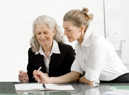 Two ladies at work looking over files