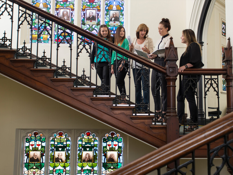 UniSA Lecturer and students on the stairs of the Brookman Building