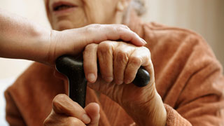 Elderly woman with walking stick