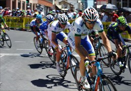 A group of cyclists riding on a bend in competition.