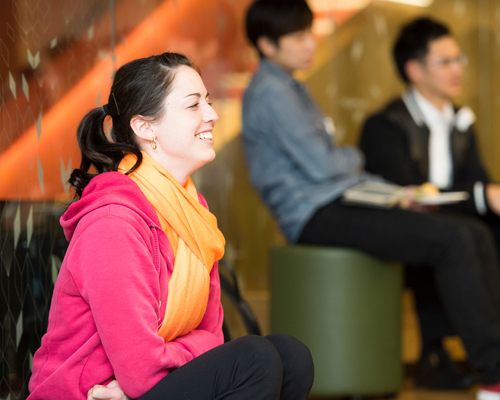 Young woman in the audience enjoying a presentation