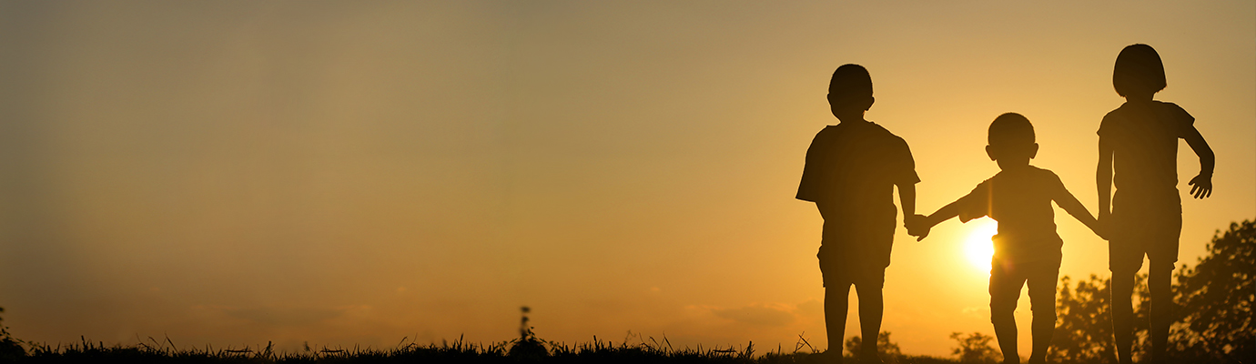 Children playing at sunset