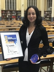 woman holding award