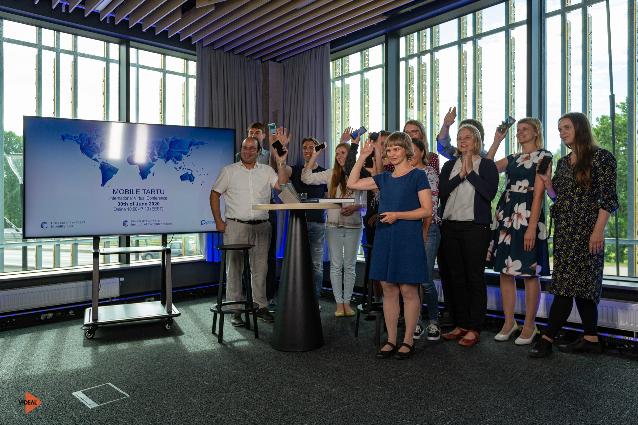 A group of people in front of a screen