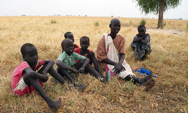 A woman and her children waiting in queue at Akot Medical Clinic in South Sudan 2016