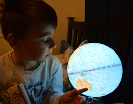 Boy looking at world globe
