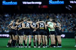 PAFC players huddle on field 