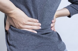 Person holding their back