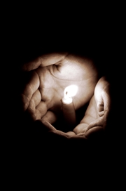 Hands holding a candle. 