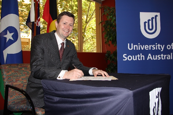 Professor David Lloyd signs the Reconciliation Action Plan