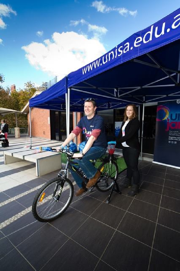Professor David Lloyd tests outs a bicycle at City East campus at a unijam party